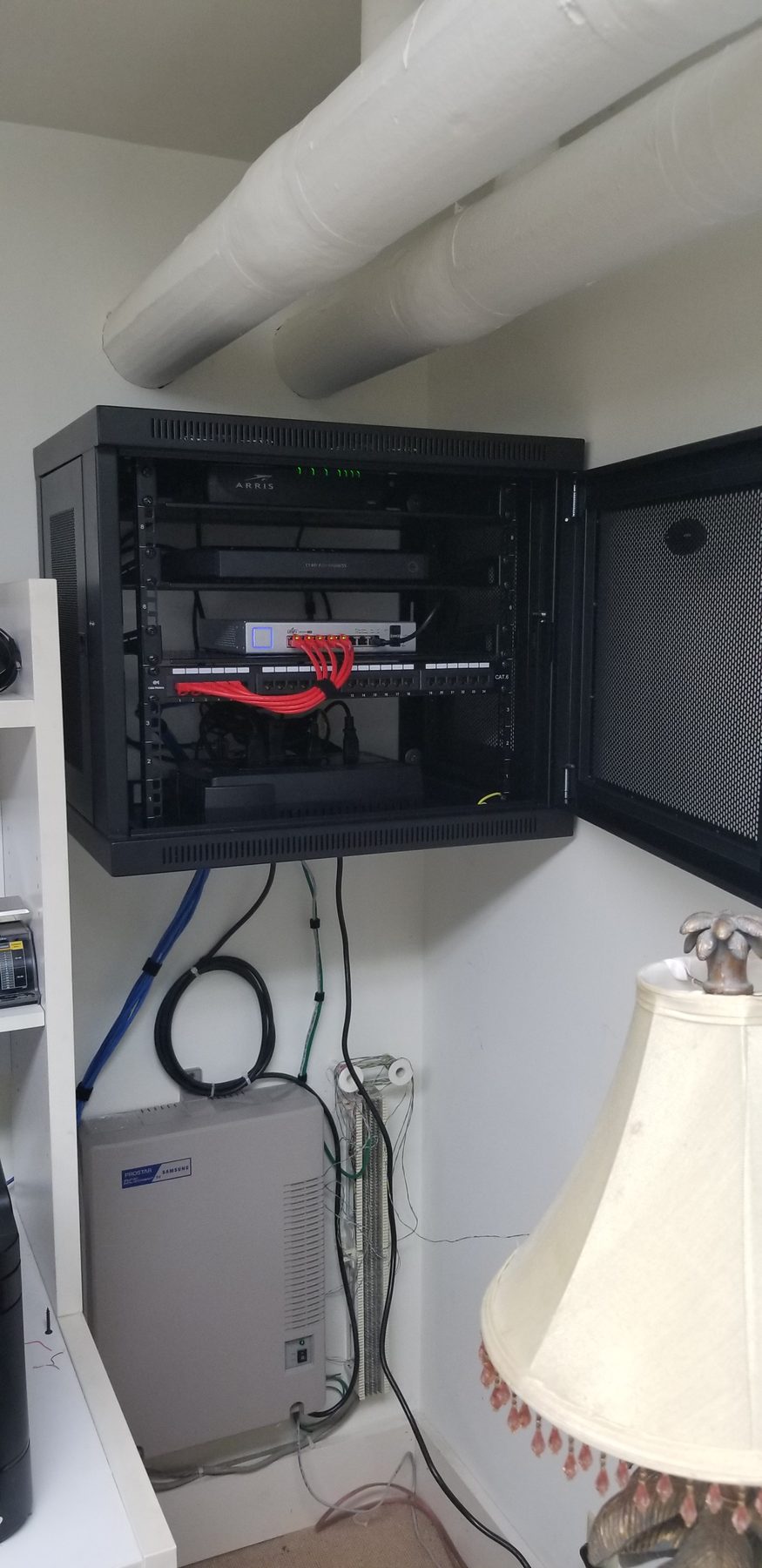 Wide view of the residential network cabinet and adjacent home communication equipment