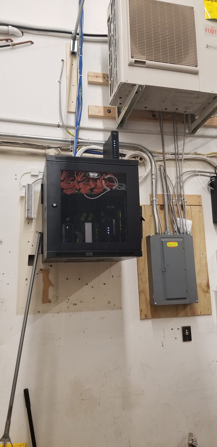Industrial utility wall after network equipment was consolidated into a lockable wall-mount cabinet