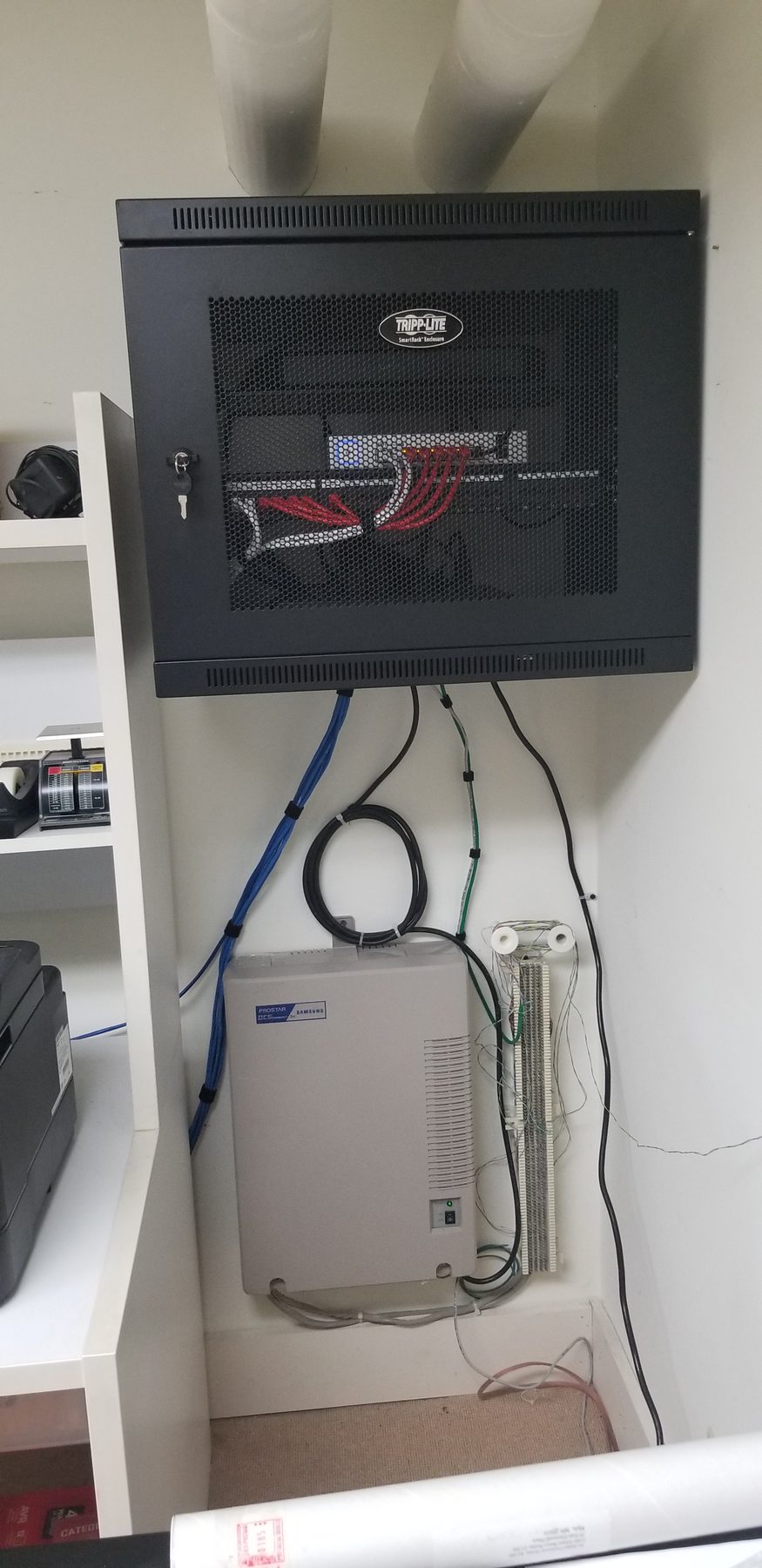 Residential network cabinet installed above the existing home telephone system