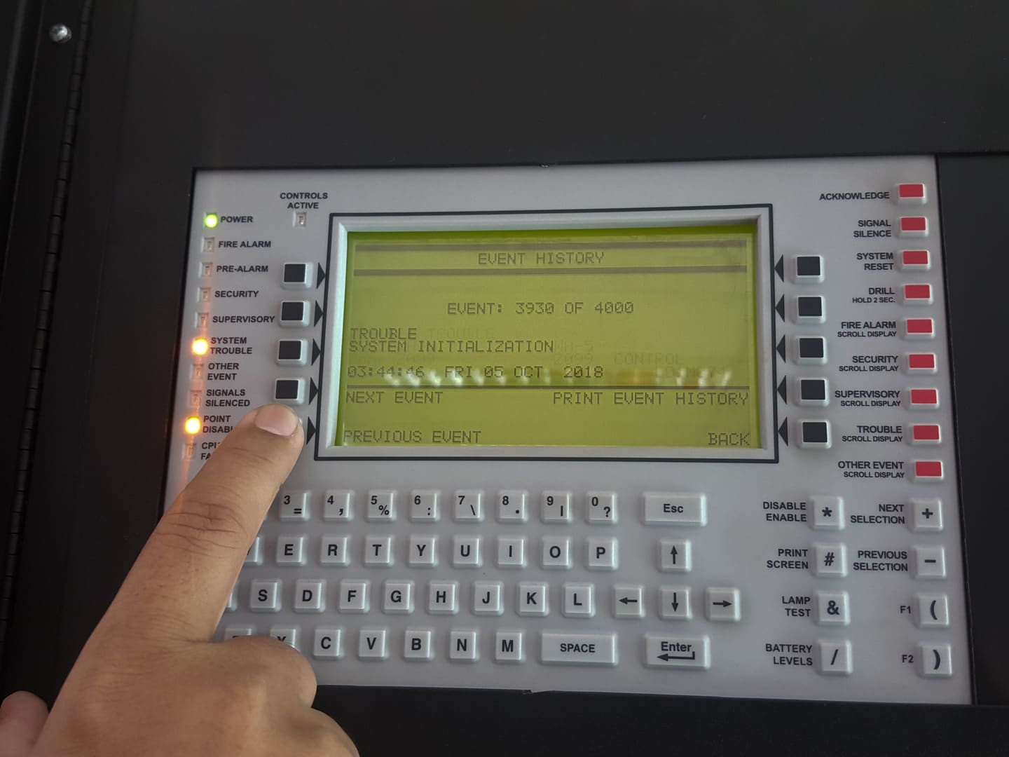 Technician reviewing a commercial intrusion alarm panel