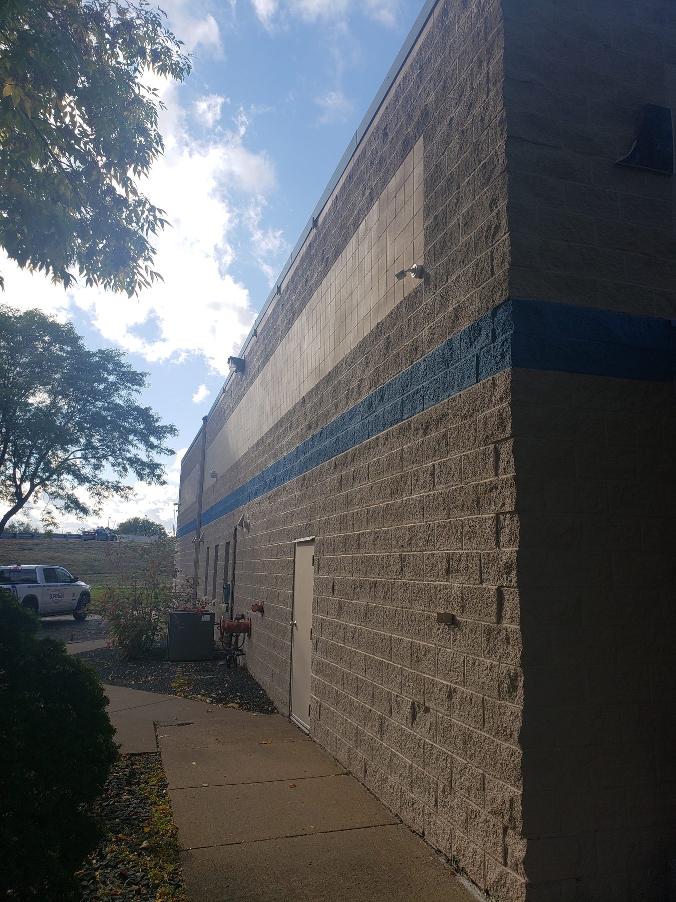 Long exterior wall and walkway with a camera mounted above to cover the full length of the approach